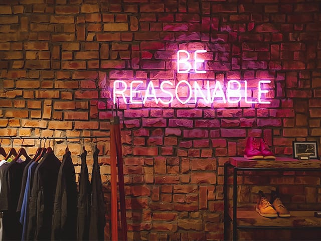Neon sign saying be reasonable